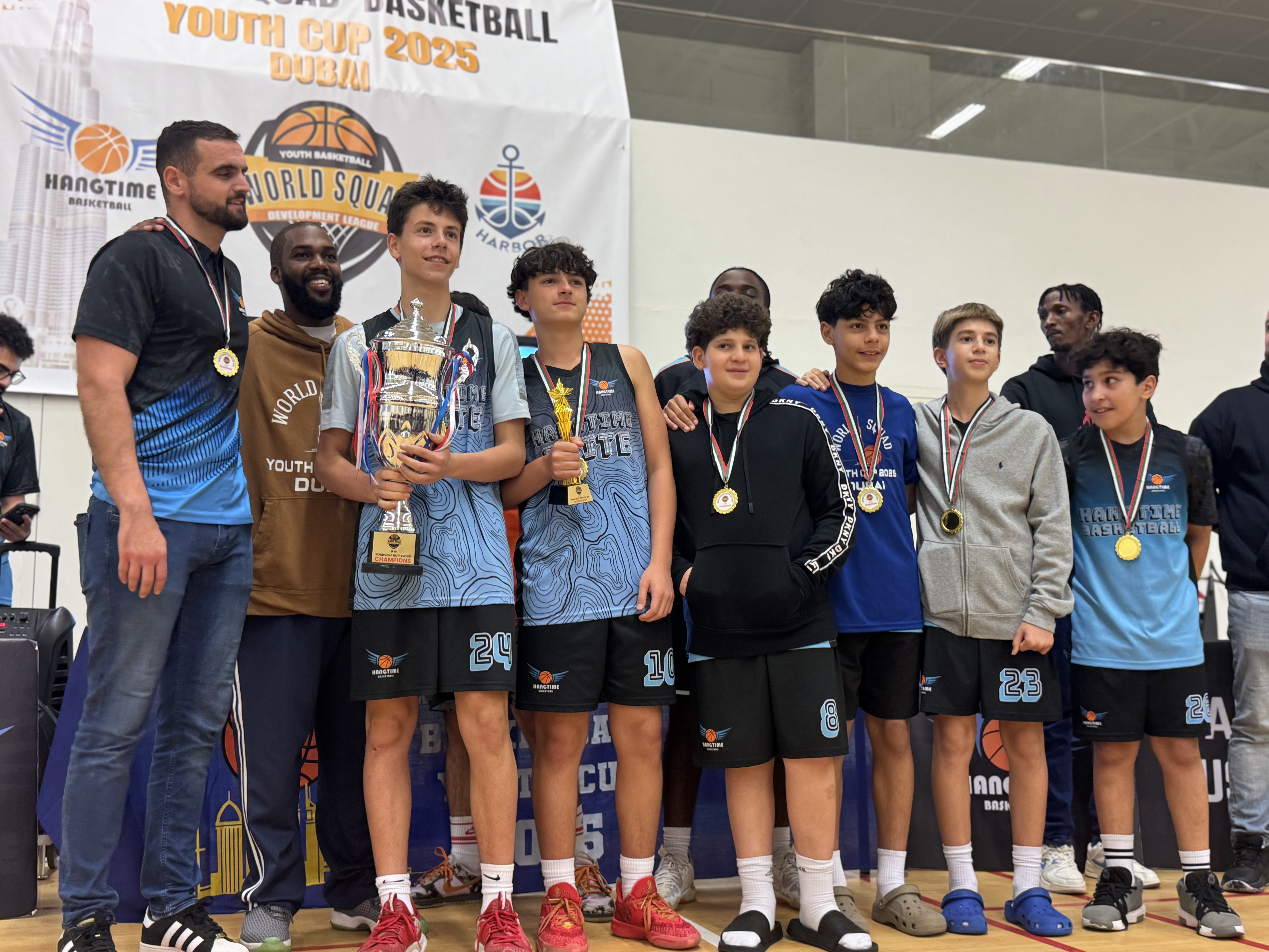 Coaches and players with trophies